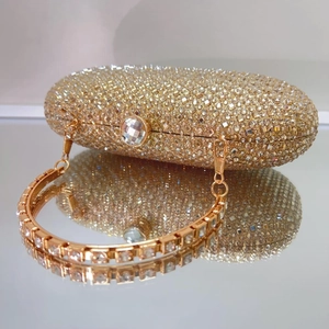 Luxurious gold evening clutch bag with sparkling rhinestones and elegant ring handle