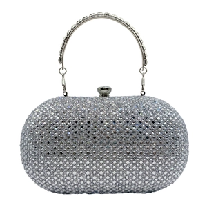 Detailed view of silver oval clutch bag with sparkling rhinestones and metal ring handle