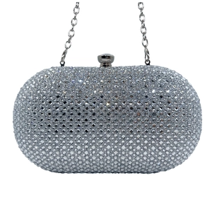 Macro shot of silver evening clutch with sparkling rhinestones and metal chain strap