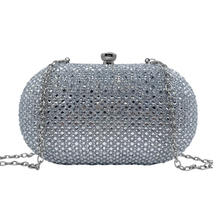 Macro shot of silver evening clutch bag featuring shiny rhinestones and metal chain