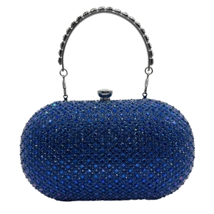 Detail of elegant blue evening clutch bag with sparkling rhinestones and silver handle