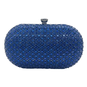 Close-up of royal blue evening clutch featuring hand-set crystals and gunmetal clasp