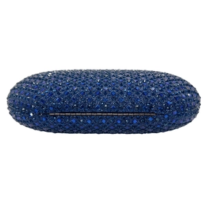 Macro shot of dark blue rhinestones on an oval evening clutch bag with metallic finish