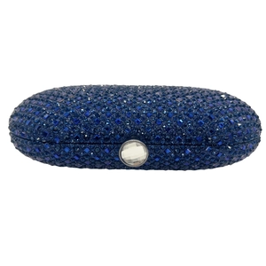 Macro shot of dark blue rhinestone clutch bag with a round gemstone snap clasp