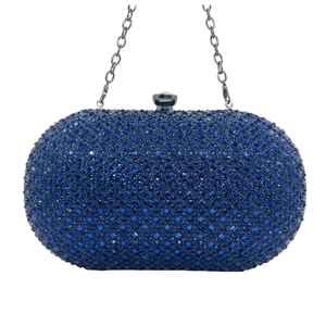 Detail of navy blue rhinestone evening clutch bag with sparkling crystals and silver chain