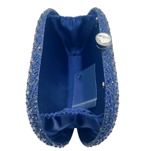 Detail view of the navy blue rhinestone clutch interior with satin lining and pocket