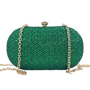 Detailed macro view of the sparkling green crystal rhinestones on the luxury evening clutch