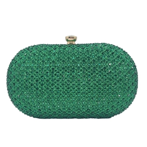 Detail view of emerald green rhinestone evening clutch bag with gold-tone metal push lock