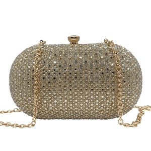Detailed macro view of the gold evening clutch featuring dense rhinestone and crystal mesh