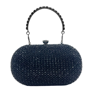 Detail of black clutch bag with sparkling rhinestones and crystal ring handle