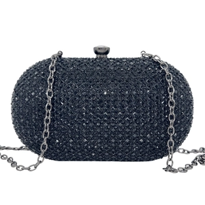 Close-up of elegant black oval evening clutch with shimmering rhinestones and metal chain