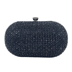Close-up of elegant black oval clutch bag with shimmering rhinestones and metal push-lock clasp