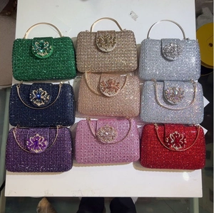 Detailed flat lay of luxury crystal clutch bags in eight colors with rhinestone ring handles