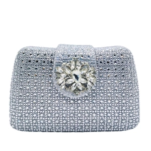 Detailed macro view of a silver rhinestone evening bag with a floral diamond clasp