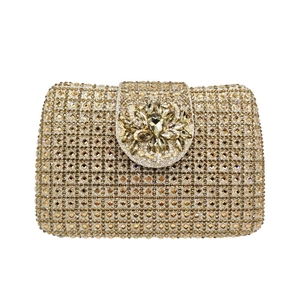 Macro view of champagne gold rhinestone evening clutch bag with crystal flower decoration