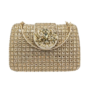 Detailed view of golden rhinestone evening clutch bag with large crystal flower clasp