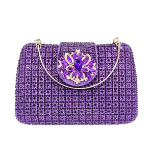 Detail of luxury purple crystal clutch bag with jewel flower and gold handle