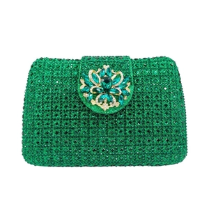 Close-up of emerald green crystal clutch bag with ornate floral rhinestone buckle