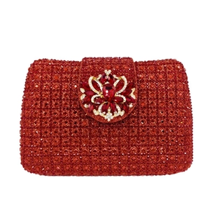 Elegant red crystal clutch bag with a central ruby-style gem and golden floral patterns