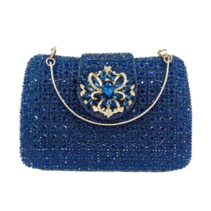 Close-up of luxury navy blue crystal evening clutch bag with ornate floral jewel clasp