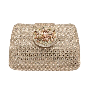 Detail of rose gold crystal clutch bag with elegant floral rhinestone clasp for parties