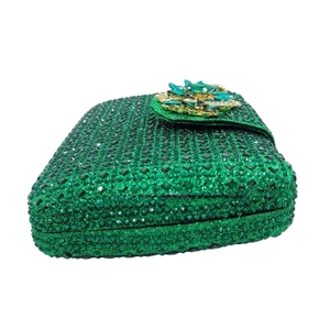 Luxurious green rhinestone evening clutch bag featuring an ornate floral emerald clasp