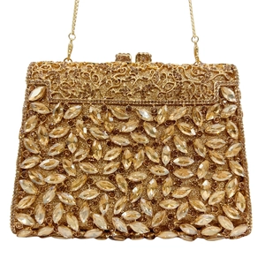 Elegant gold clutch bag with marquise crystals, metal frame and chain strap for evening parties