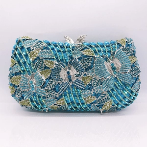 Detailed macro view of crystal butterfly and floral pattern on a luxury evening clutch bag