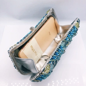 Internal view of silver crystal clutch bag showing capacity for a large smartphone