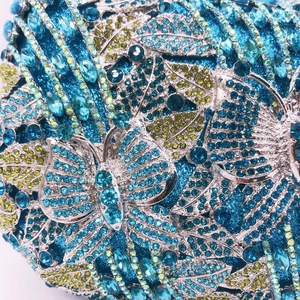 Macro detail of luxury butterfly evening clutch with blue rhinestones and silver filigree