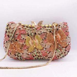 Detail of the hollow metal butterfly clutch featuring colorful rhinestones and gold chain