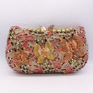 Detailed macro view of the crystal butterfly clasp on a luxury floral evening clutch bag