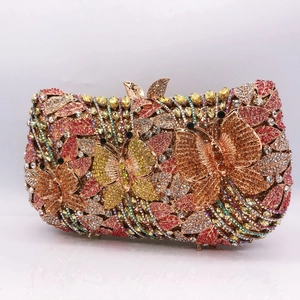 Detail of luxury crystal evening clutch bag featuring colorful floral butterfly design