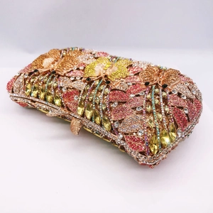 Detail showing hand-set colorful rhinestones and butterfly flower patterns on clutch