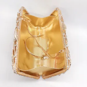 Detailed interior of gold music note clutch with rhinestones and metal chain strap