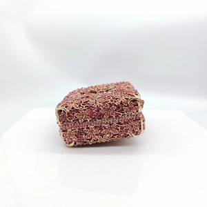Pink crystal flower evening clutch bag with golden metal hollow frame in 45-degree view