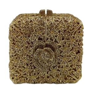 Detail of golden floral evening bag with intricate crystal roses and metallic clasp