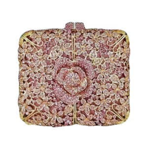 Macro detail of pink crystal flower clutch with gold metal frame for evening parties
