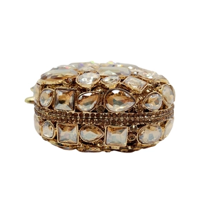Detailed close-up of amber gold crystal clutch with teardrop and square rhinestones