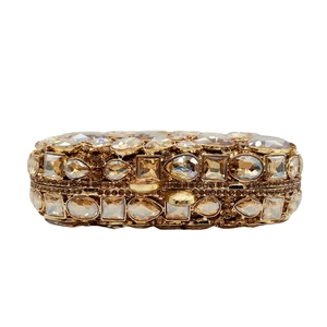 Detailed view of champagne gold evening clutch with multi-shape crystal embellishments