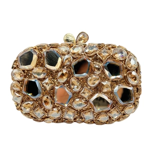 Macro shot of gold evening clutch featuring oversized crystals and faceted rhinestones