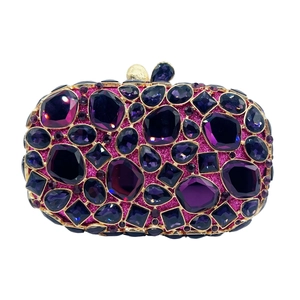 Macro view of purple gemstone crystals and sequins on a luxury evening clutch bag