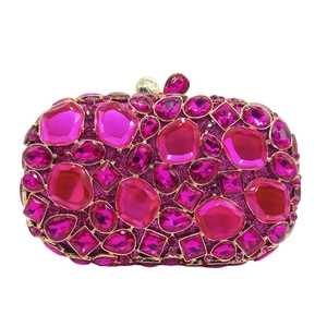 Macro shot of rose pink gemstones and crystals set in a golden frame luxury clutch