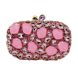 Detail of pink crystal clutch bag with rhinestone embellishments and butterfly clasp