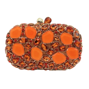 Detailed view of orange stone clutch bag with crystal embellishments and gold leaf clasp