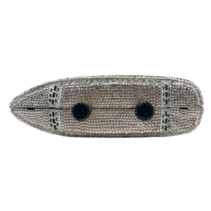 Macro detail of yacht-shaped evening clutch bag with sparkling silver and black crystals