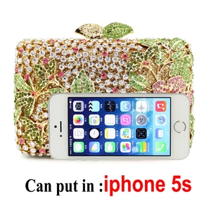 Floral crystal evening bag with green rhinestones shown with iPhone for size scale