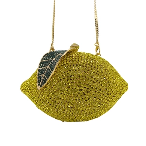 Luxury lemon-shaped evening clutch bag with bright yellow crystals and gold chain strap