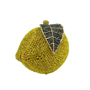 Detailed view of luxury lemon evening clutch bag with yellow and green crystal rhinestones