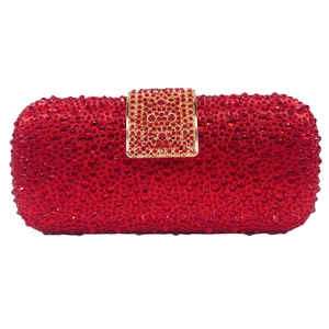 Detail of red rhinestone clutch bag featuring luxury crystal mesh and gold rectangle clasp